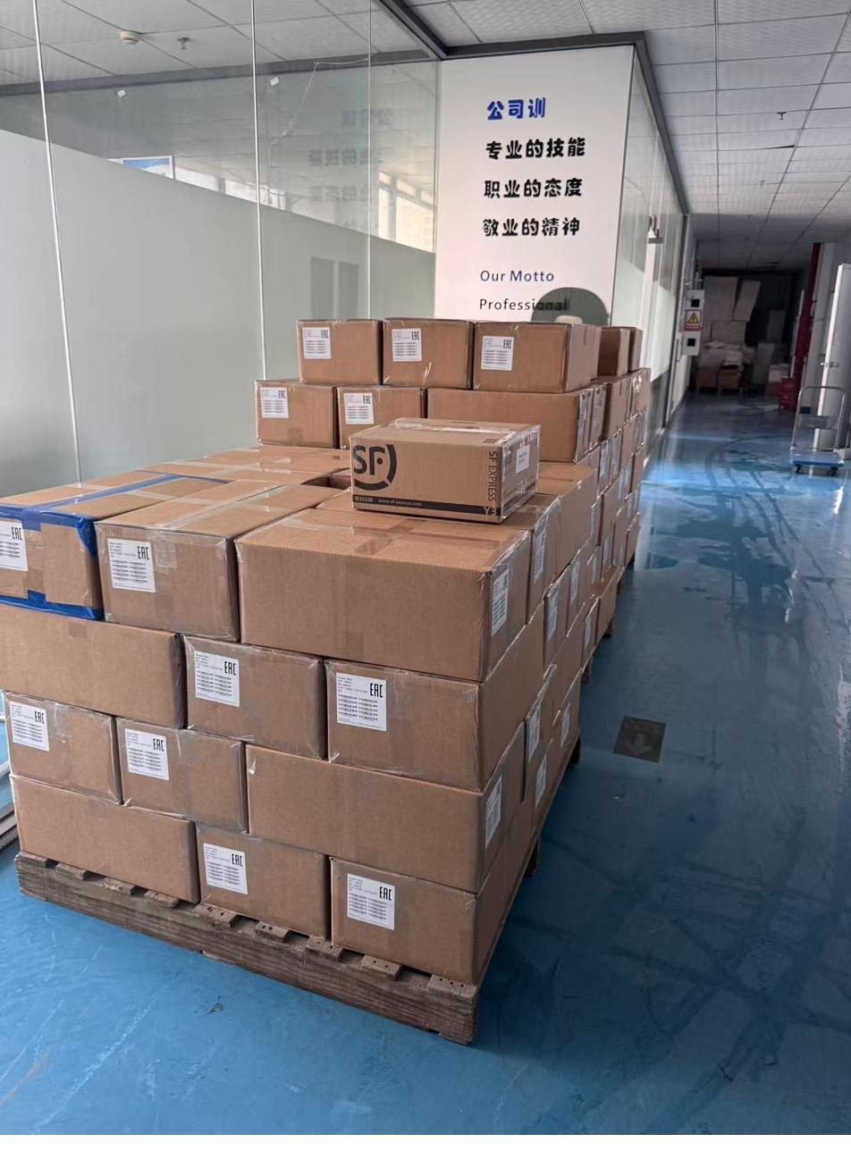 Second view of palletized EAC-labeled OPS PC shipment in a Shenzhen facility corridor